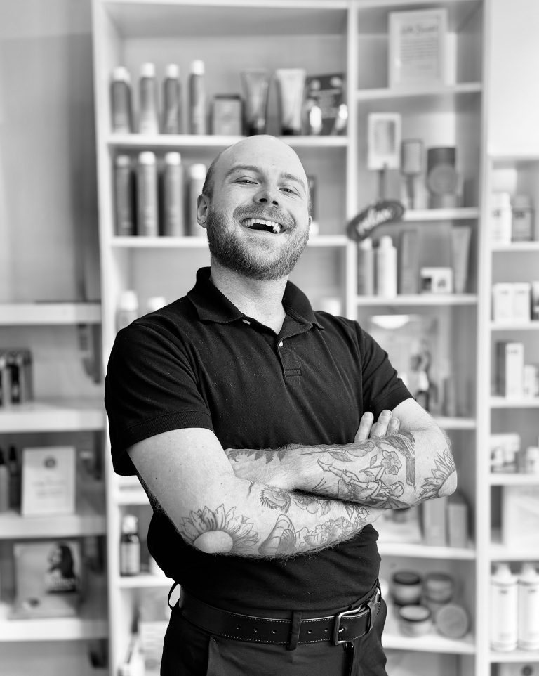 Austin Kvasnikoff smiling in the Fringe salon