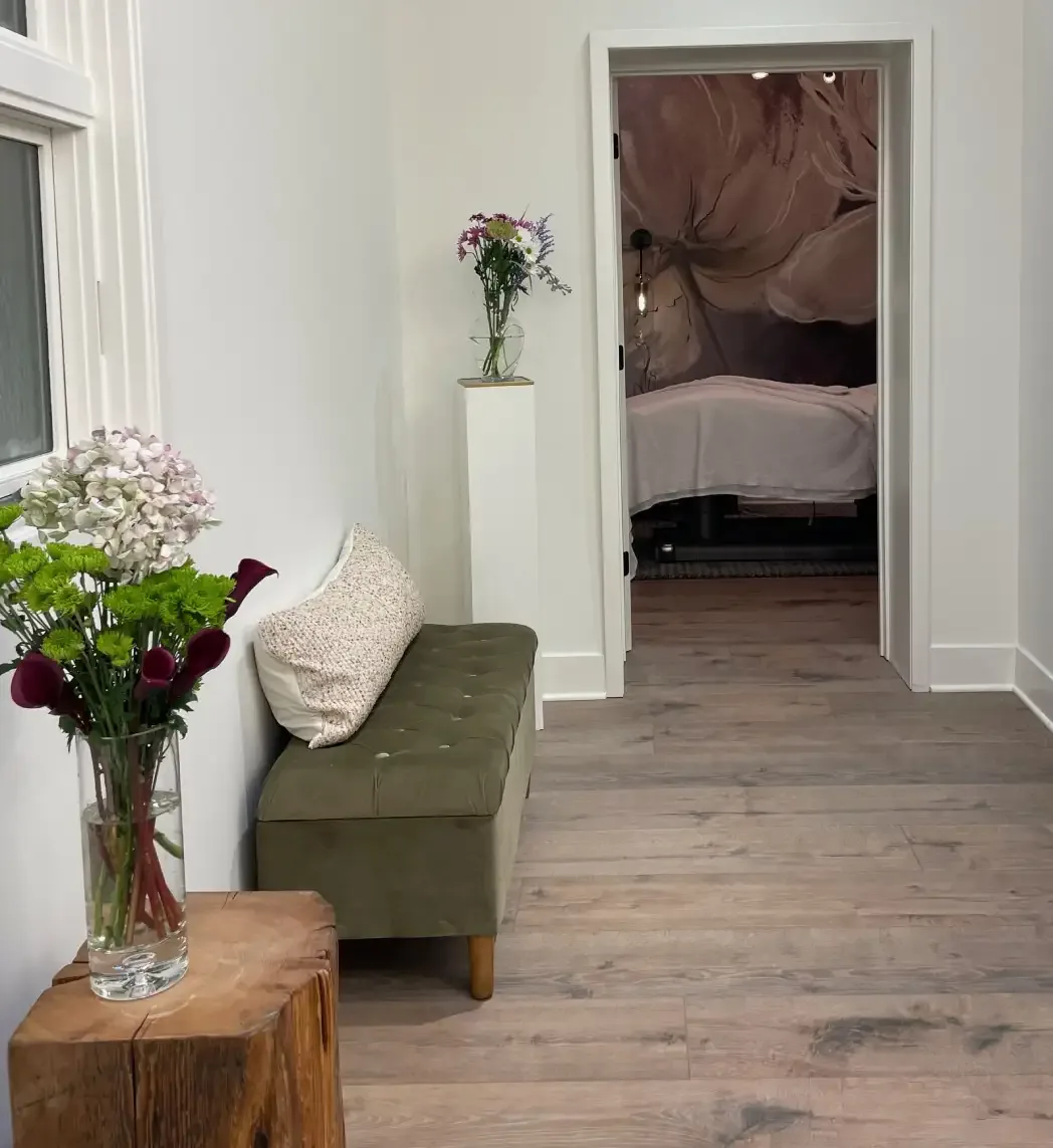 Fringe treatment room entrance with bench and fresh flowers